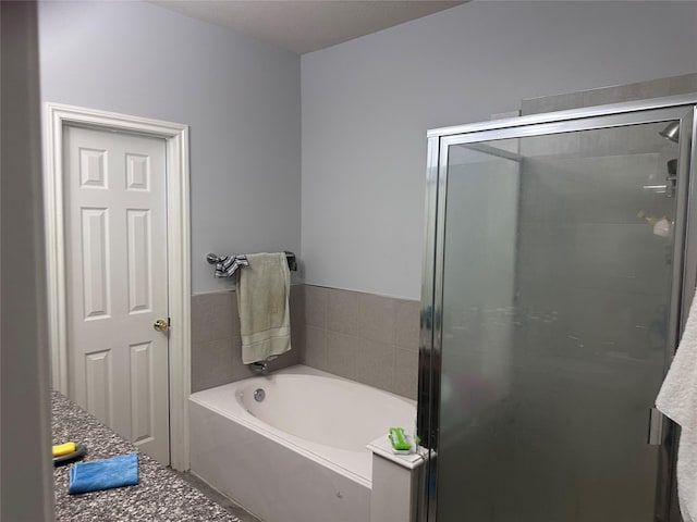 bathroom with shower with separate bathtub