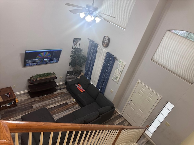 living room featuring ceiling fan and hardwood / wood-style flooring