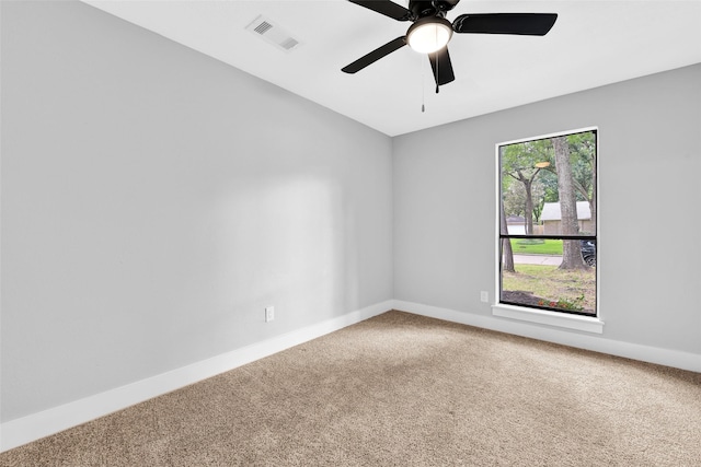 empty room with ceiling fan and carpet floors