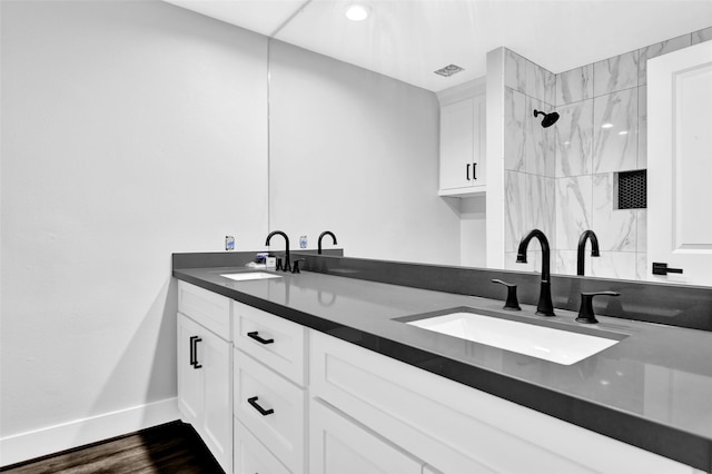 bathroom with vanity, wood-type flooring, and walk in shower