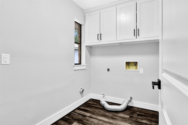 washroom featuring dark wood-type flooring, cabinets, washer hookup, hookup for an electric dryer, and gas dryer hookup