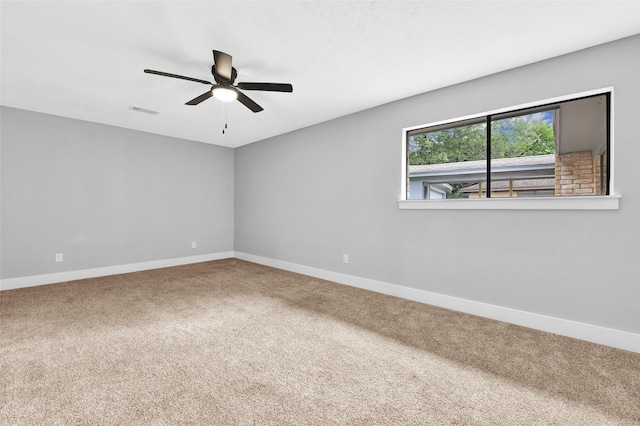 empty room featuring carpet flooring and ceiling fan