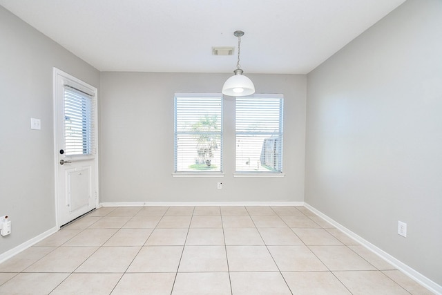 tiled spare room with a wealth of natural light