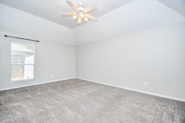 empty room featuring carpet flooring, ceiling fan, and vaulted ceiling