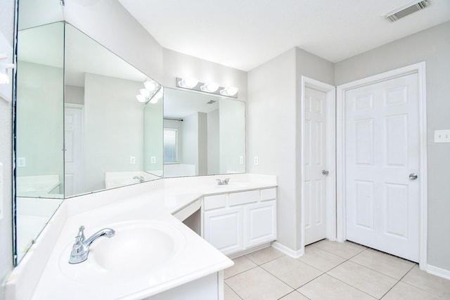 bathroom featuring tile patterned flooring and vanity