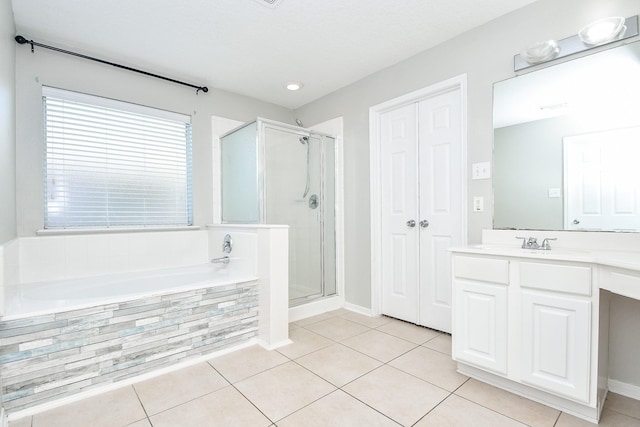 bathroom with shower with separate bathtub, tile patterned floors, and vanity