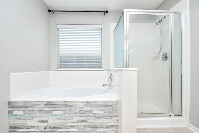 bathroom with independent shower and bath and tile patterned floors