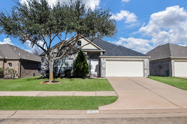 view of front of home with a front yard and a garage