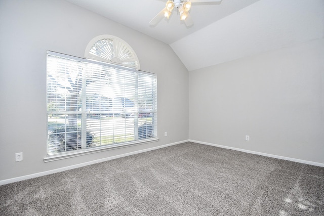 carpeted empty room with ceiling fan and vaulted ceiling