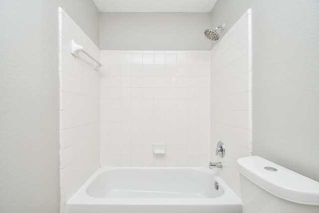 bathroom with shower / bathing tub combination and toilet