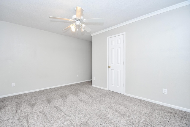 carpeted empty room with ceiling fan, ornamental molding, and a textured ceiling