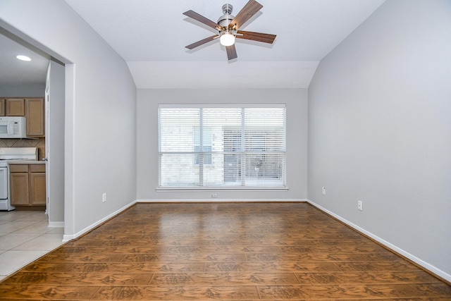 unfurnished room featuring ceiling fan, dark wood-type flooring, and vaulted ceiling