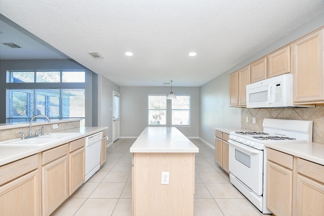 kitchen with white appliances, a center island, light brown cabinetry, decorative backsplash, and sink