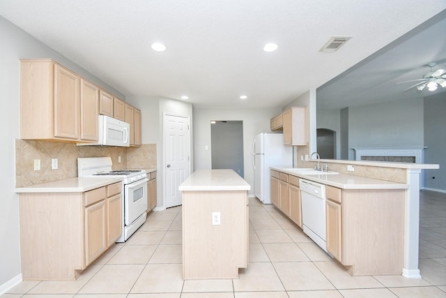 kitchen featuring white appliances, kitchen peninsula, light brown cabinetry, tasteful backsplash, and sink