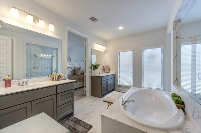 bathroom with vanity and independent shower and bath