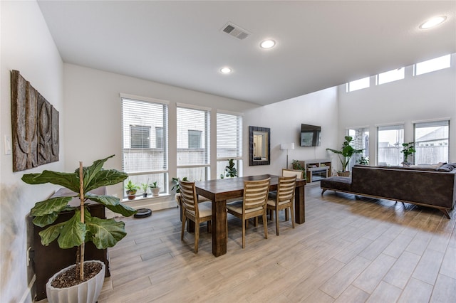 dining space with a wealth of natural light and light hardwood / wood-style flooring