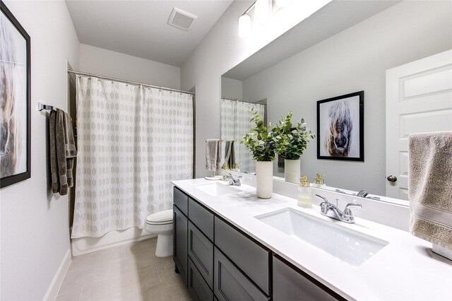 full bathroom with tile patterned floors, vanity, toilet, and shower / tub combo with curtain