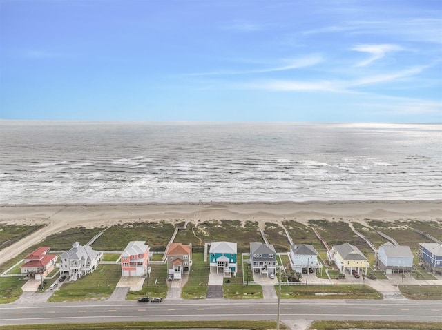 birds eye view of property with a water view and a view of the beach