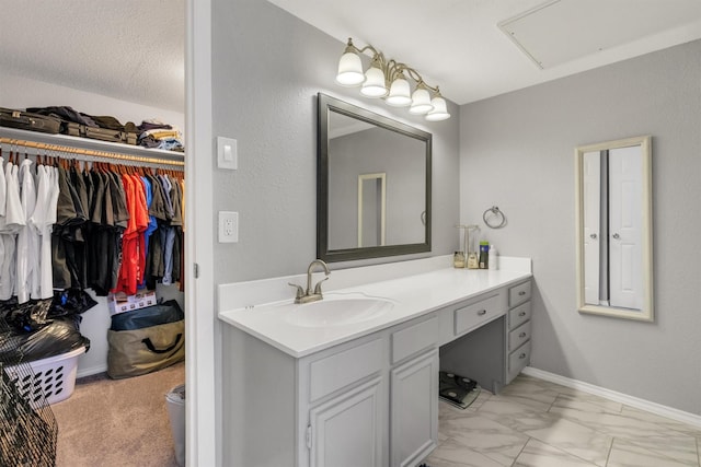 bathroom with a textured ceiling and vanity