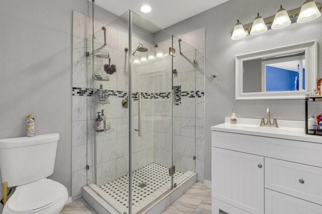 bathroom featuring vanity, toilet, and an enclosed shower