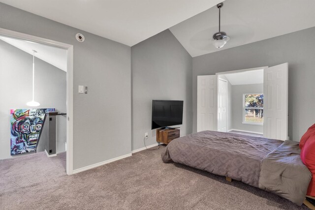 carpeted bedroom with ceiling fan and vaulted ceiling