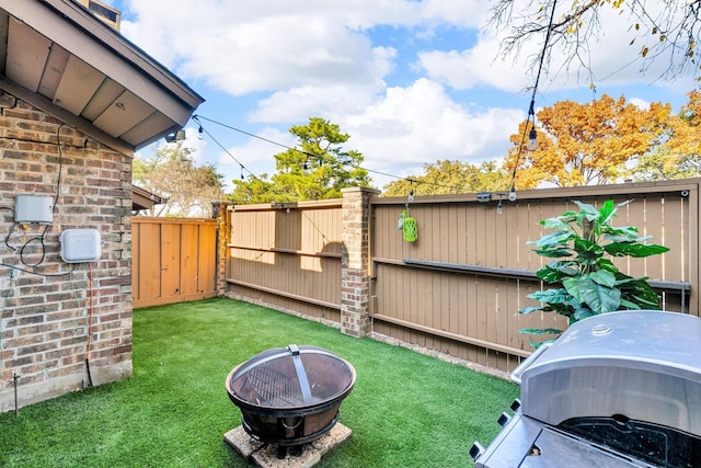 view of yard with an outdoor fire pit