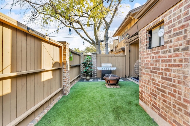 view of yard with a fire pit