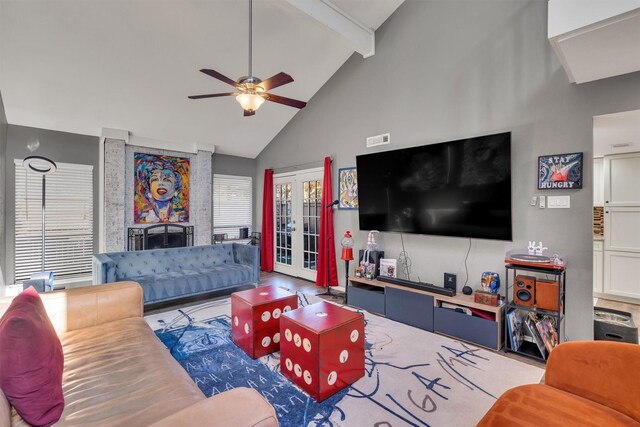 living room featuring beam ceiling, ceiling fan, french doors, and high vaulted ceiling