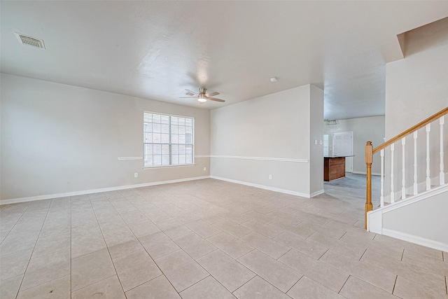 unfurnished room with ceiling fan and light tile patterned flooring