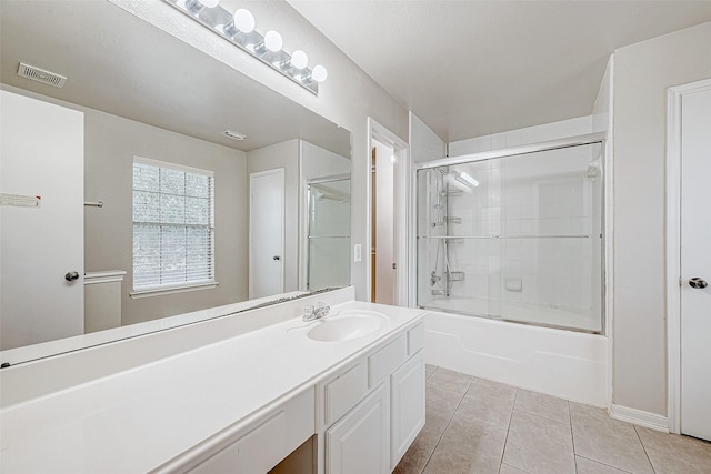 bathroom with vanity, shower / bath combination with glass door, and tile patterned flooring