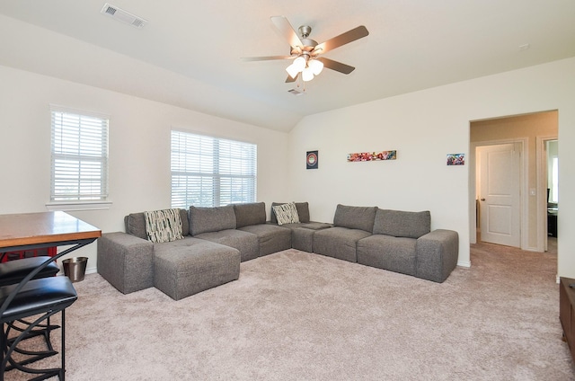 carpeted living room featuring ceiling fan and lofted ceiling