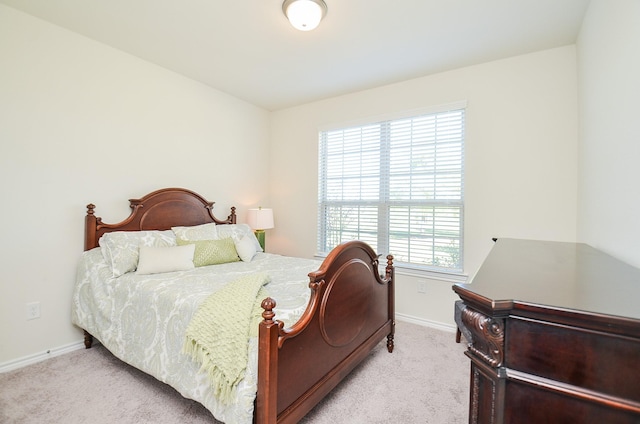 bedroom featuring multiple windows and light colored carpet