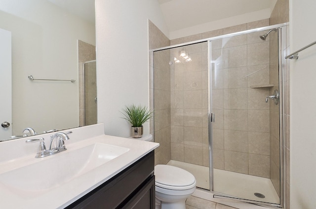 bathroom with tile patterned floors, vanity, toilet, and an enclosed shower