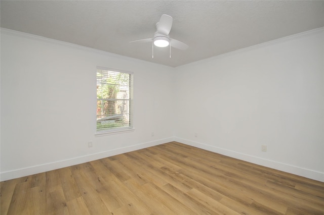 empty room with crown molding, ceiling fan, and light wood-type flooring