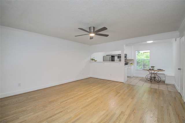 unfurnished living room with crown molding, ceiling fan, light hardwood / wood-style floors, and a textured ceiling