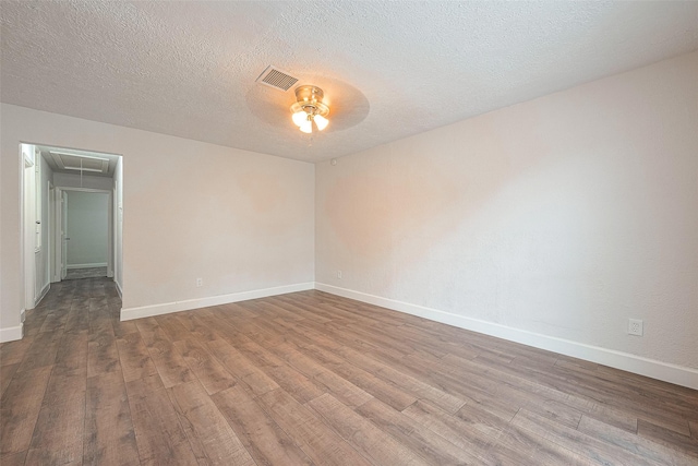 unfurnished room with ceiling fan, light hardwood / wood-style flooring, and a textured ceiling