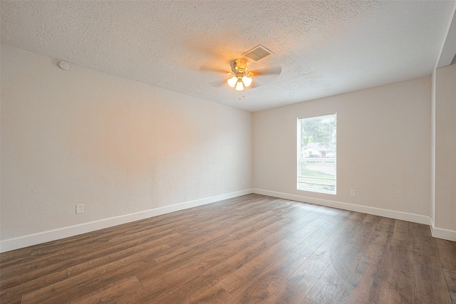 spare room featuring a textured ceiling, ceiling fan, and dark wood-type flooring