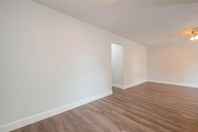 spare room featuring wood-type flooring, a textured ceiling, and ceiling fan