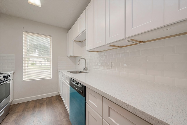 kitchen with white cabinets, light stone counters, backsplash, and appliances with stainless steel finishes