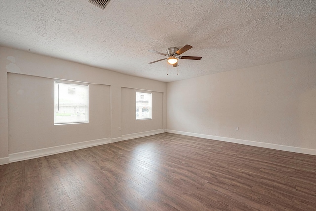 spare room featuring a textured ceiling, dark hardwood / wood-style floors, and ceiling fan