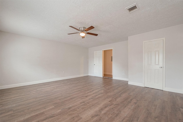 spare room with ceiling fan, dark hardwood / wood-style floors, and a textured ceiling