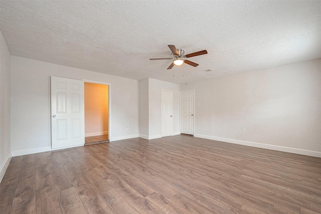 unfurnished room with ceiling fan, a textured ceiling, and hardwood / wood-style flooring