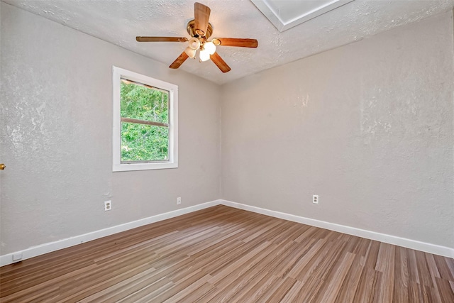 unfurnished room featuring hardwood / wood-style floors, a textured ceiling, and ceiling fan