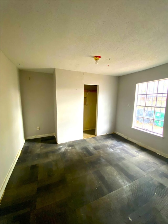 spare room with a textured ceiling