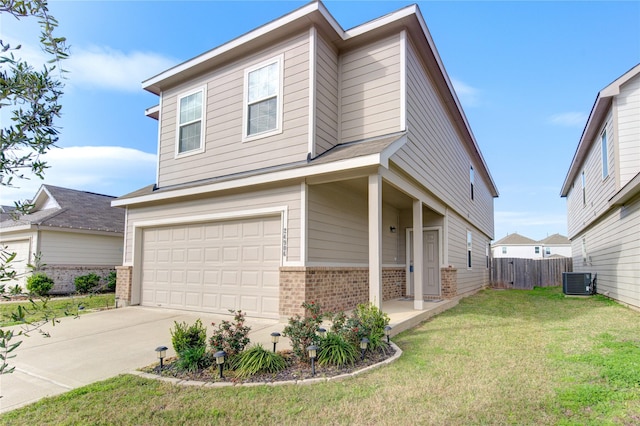 view of front of home featuring central AC, a garage, and a front lawn