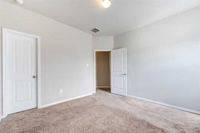 unfurnished room featuring light carpet