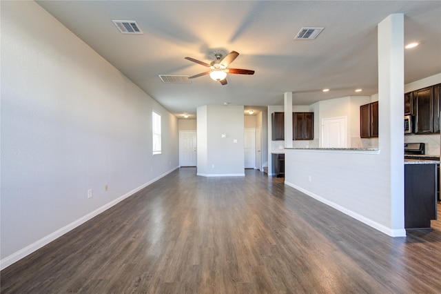 unfurnished living room featuring ceiling fan and dark wood-type flooring