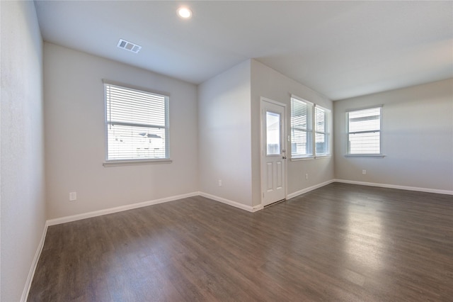 unfurnished room with dark hardwood / wood-style flooring