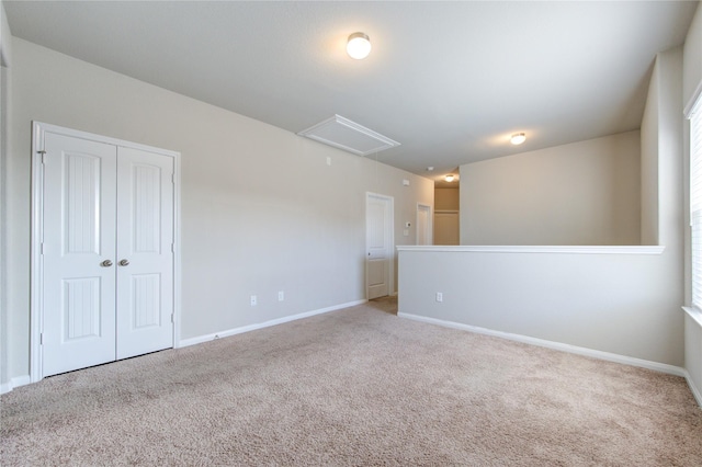 spare room featuring light colored carpet