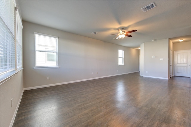 spare room featuring dark hardwood / wood-style flooring and ceiling fan